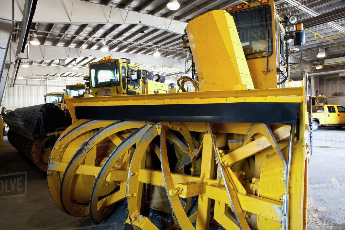 Close up of snowplow parked in warehouse Stock Photo Dissolve