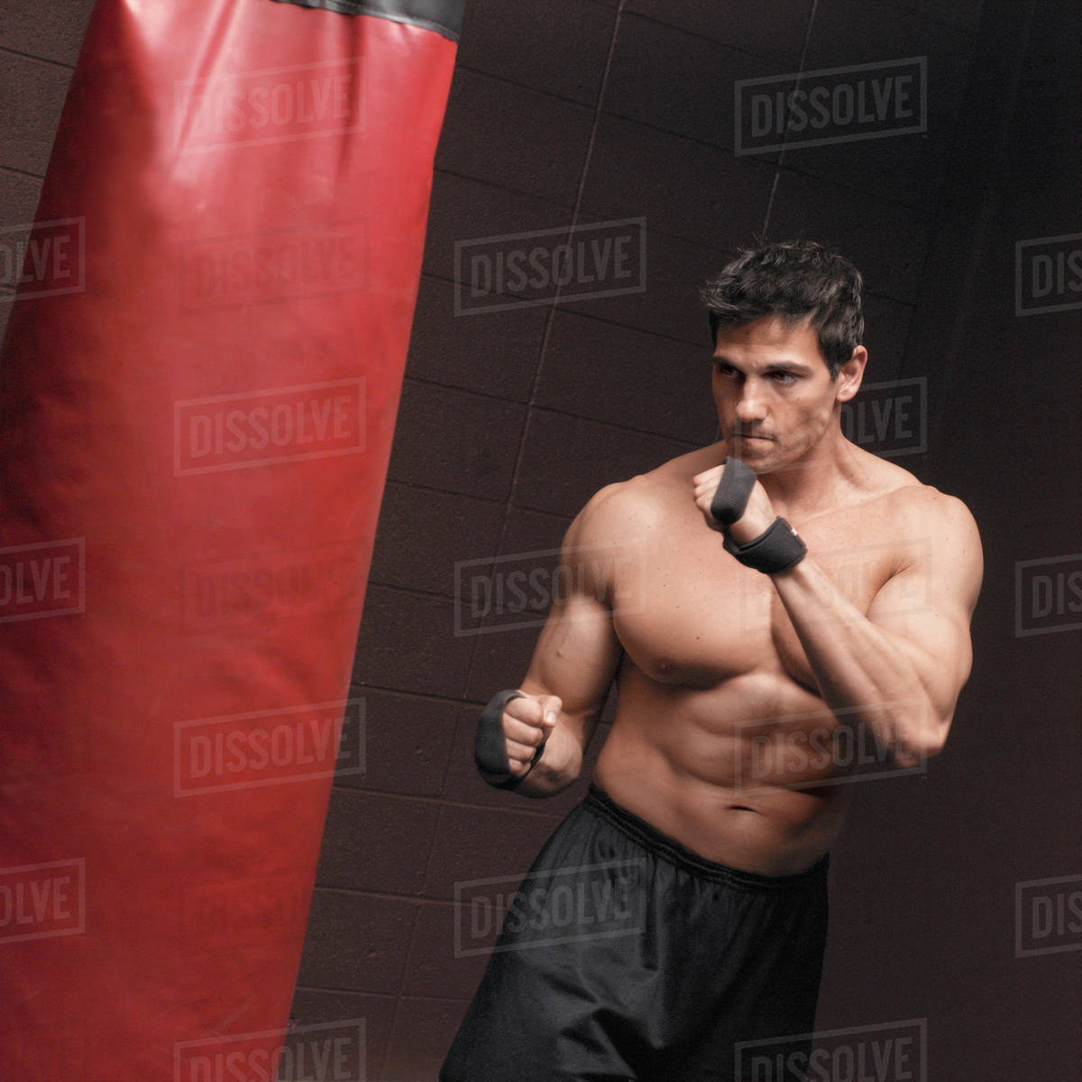 Caucasian Man Using Punching Bag Stock Photo