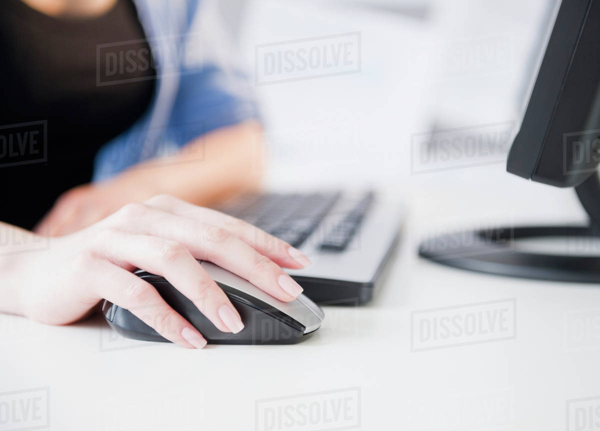 Close up of Korean woman using computer mouse Stock Photo Dissolve