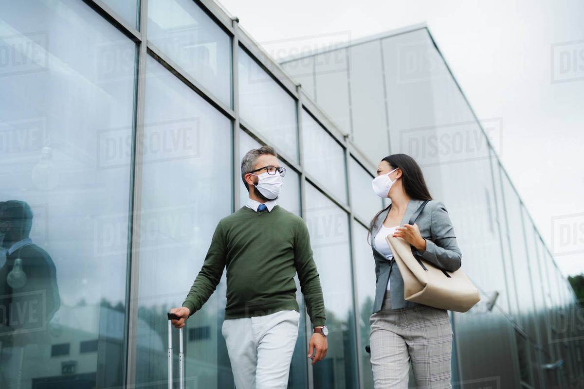 Man and woman businesspeople with luggage going on business trip