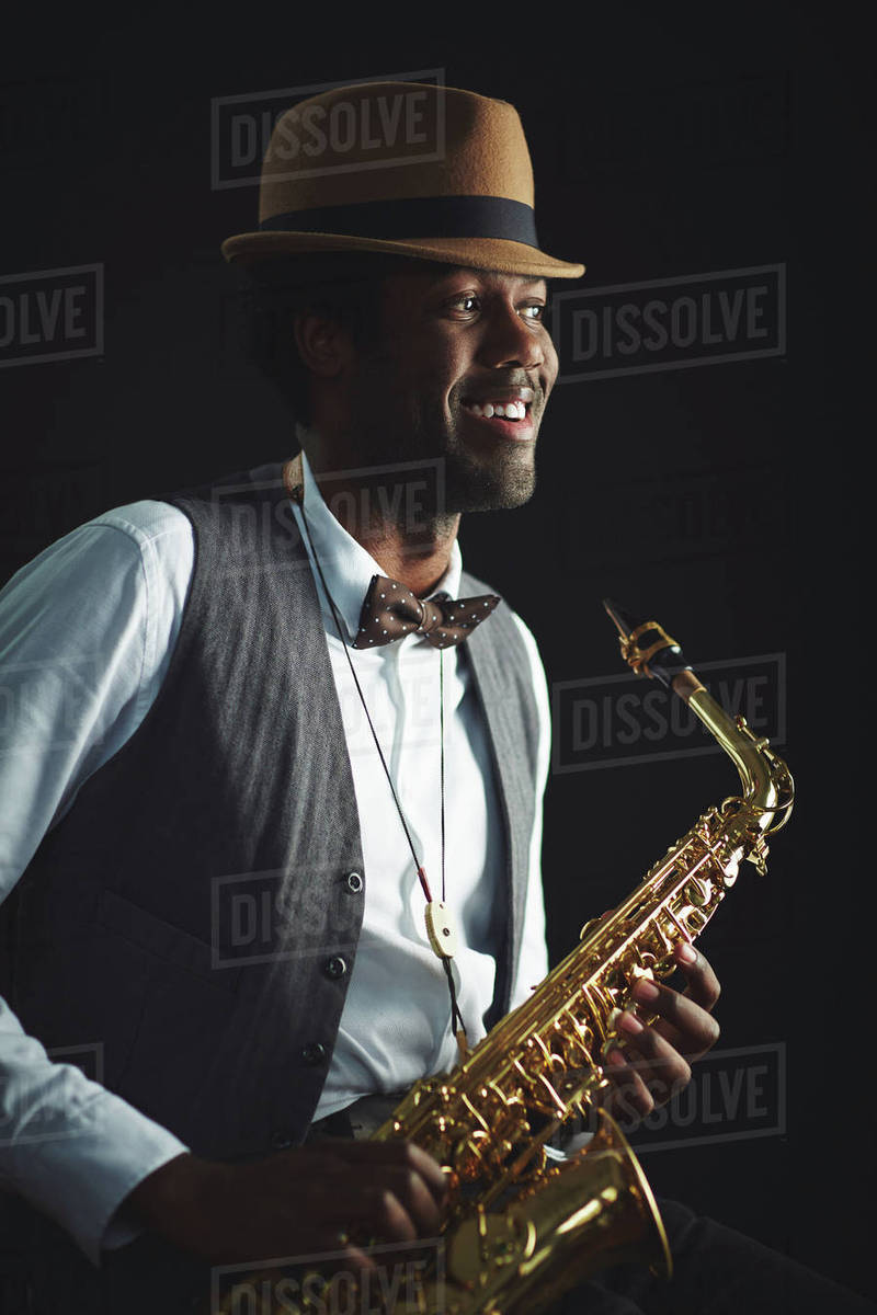 Happy young jazzman with sax Stock Photo Dissolve