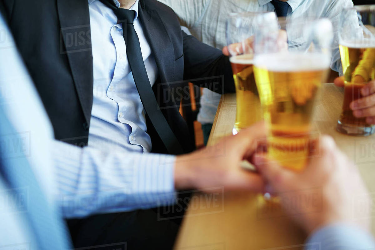 Successful employees having beer after work Stock Photo Dissolve