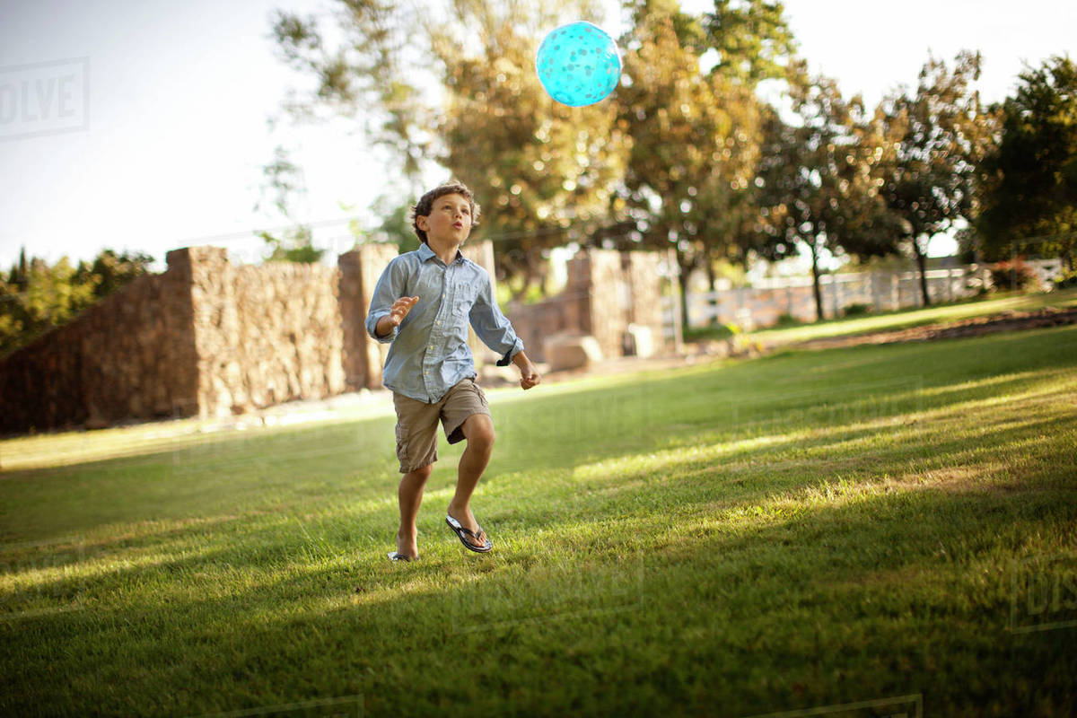 Young boy playing with a ball in a park. - Royalty-free Stock Photo ...