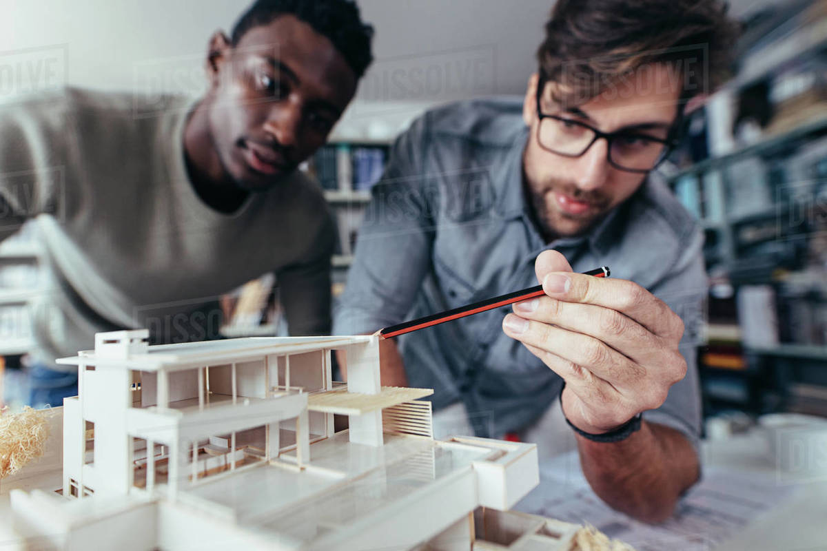 Two young architects working on new architectural house model