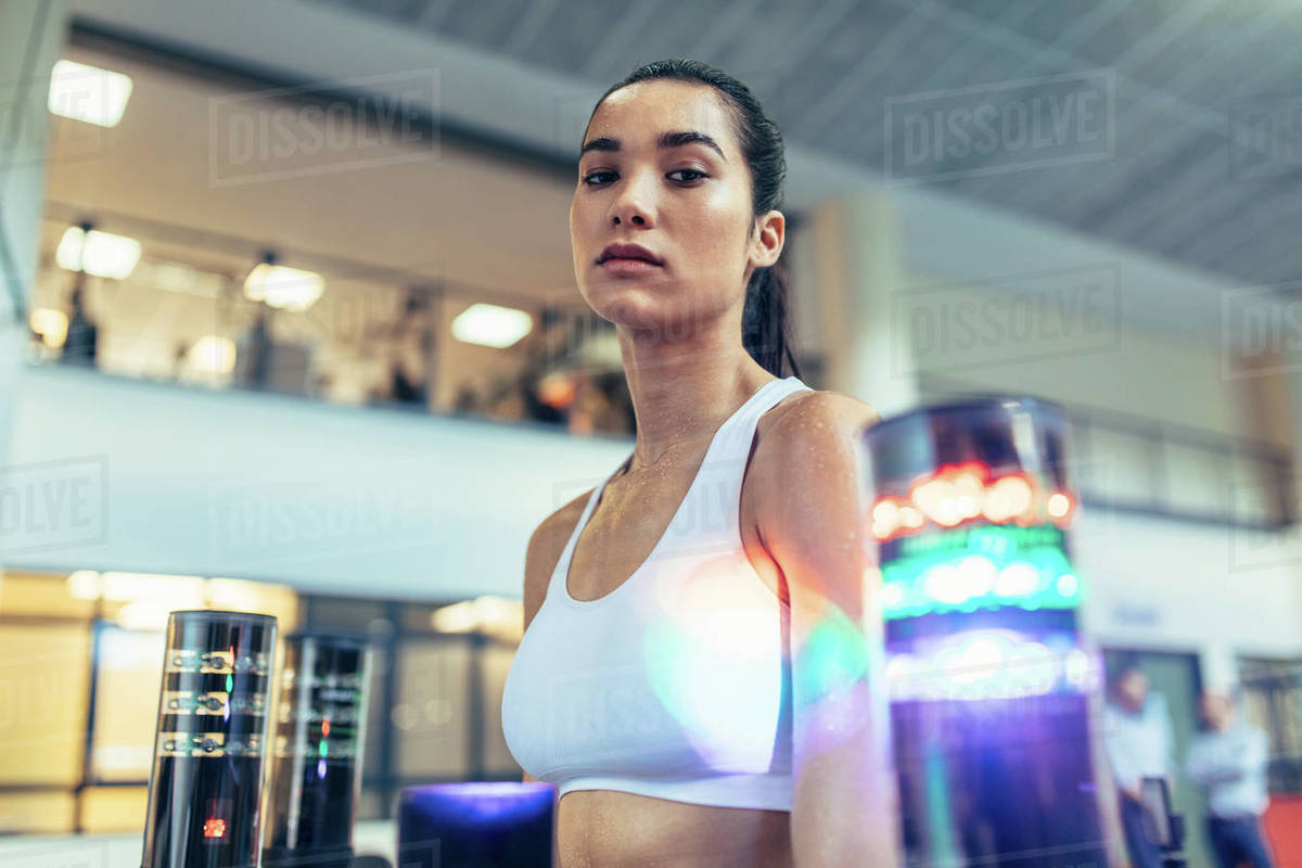 Reaction time training session at gym. Female athlete with visual stimulus system to improve