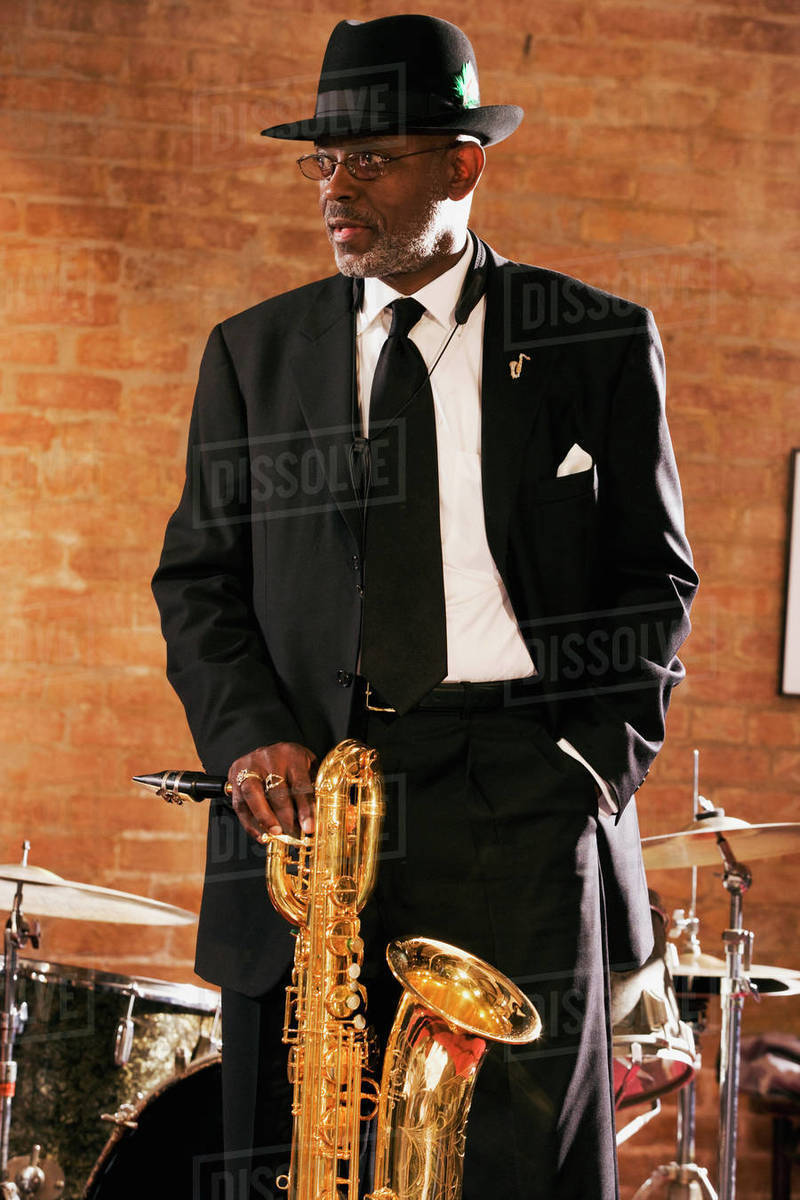 African man holding saxophone Stock Photo Dissolve