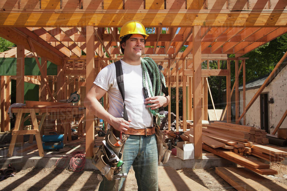 Portrait of a construction worker wearing a hard hat and a tool belt