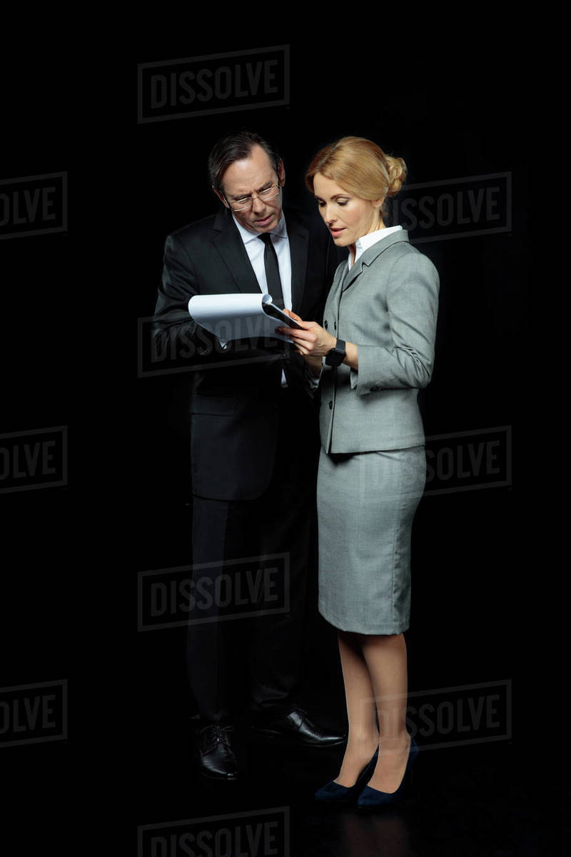 Full length view of businesspeople discussing and signing papers on