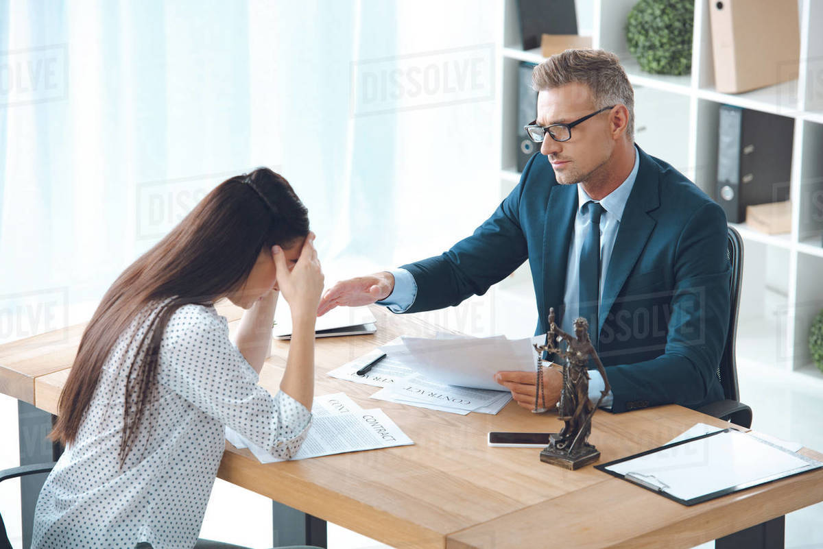 Lawyer working with upset female client in office Stock Photo Dissolve