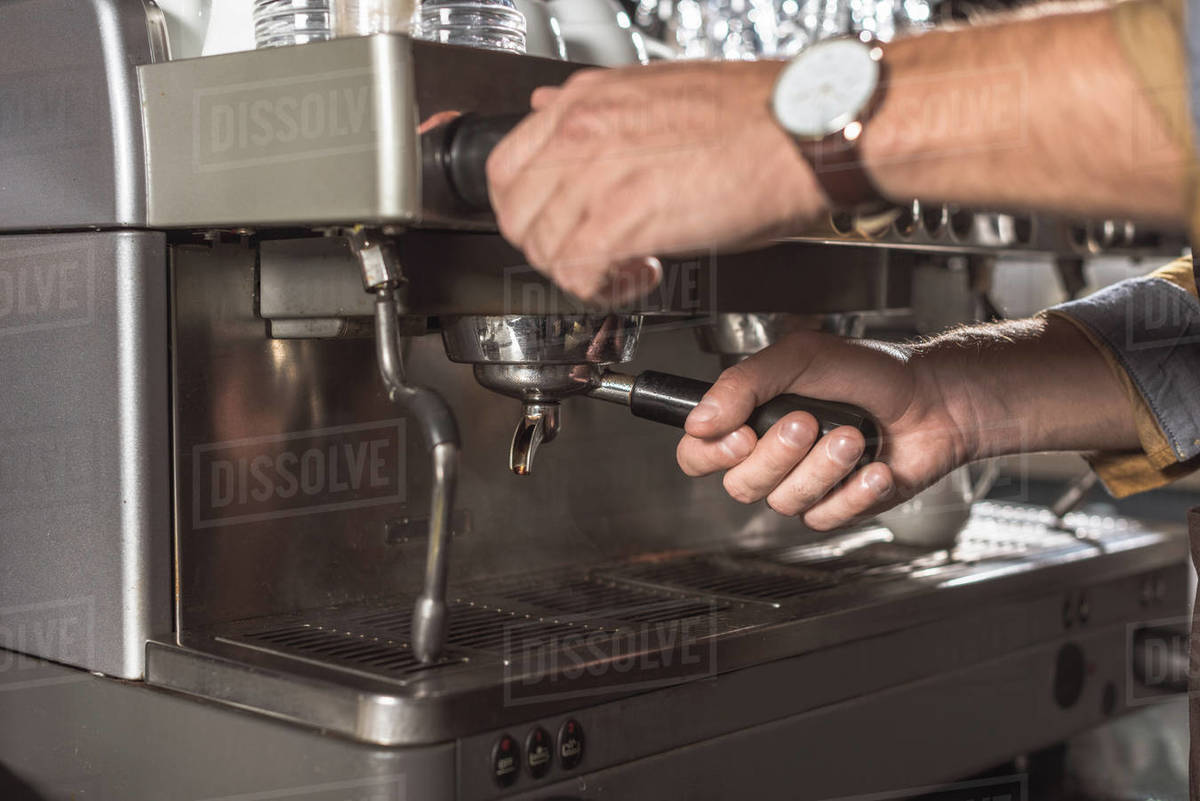 Cropped shot of barista using coffee machine in restaurant Stock