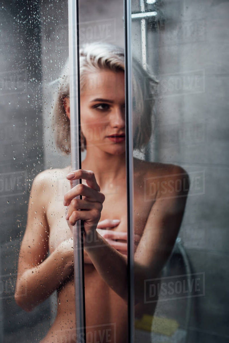 nude woman shower Naked sensual woman holding shower door, looking away and posing in  bathroom - Stock Photo - Dissolve