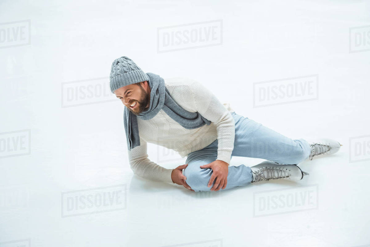 Man injured knee while skated on ice rink Stock Photo Dissolve