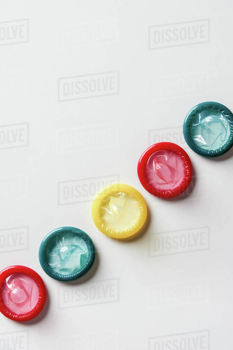 Top view of multicolored condoms on white background Stock Photo