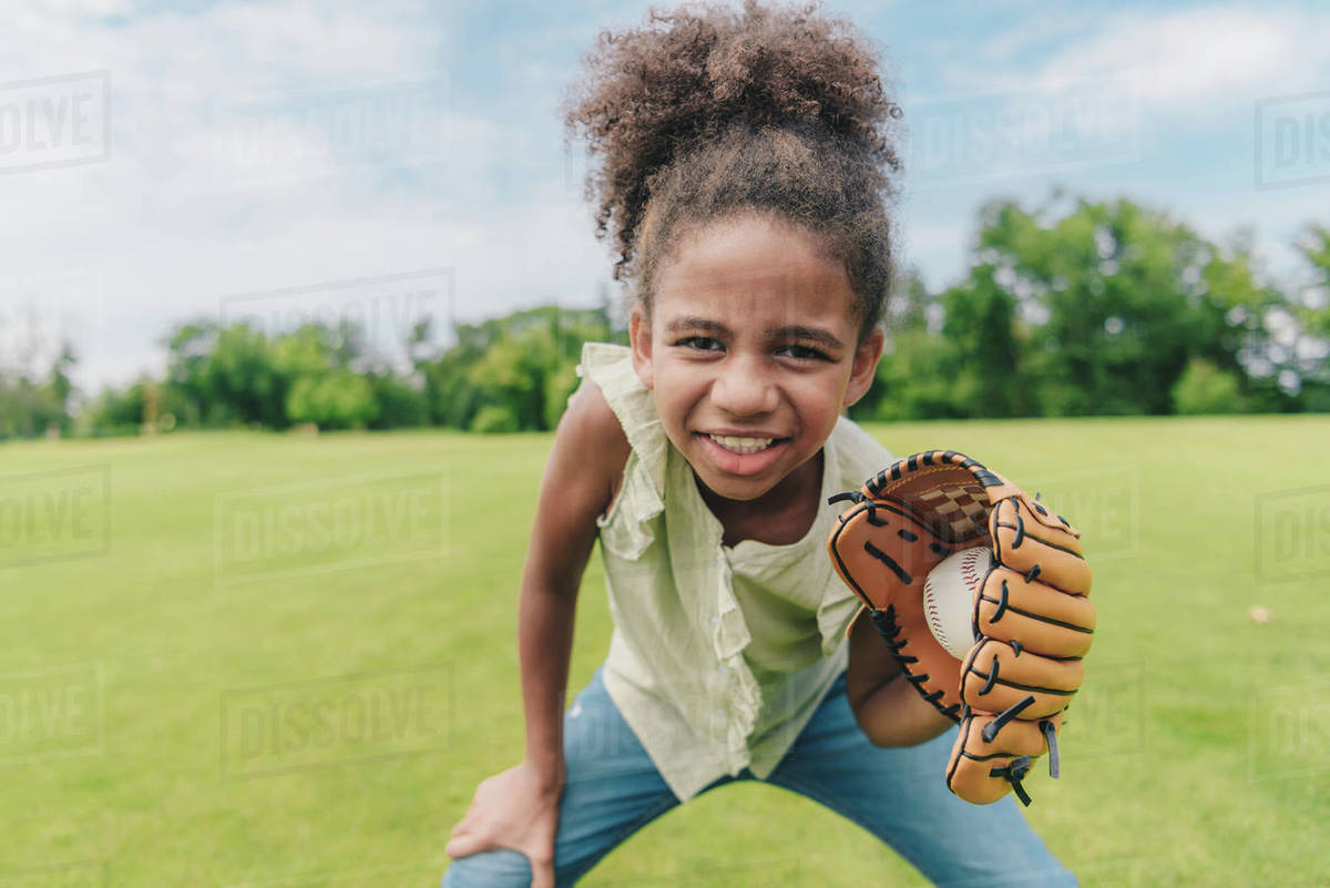 Portrait of smiling African American little girl with baseball glove