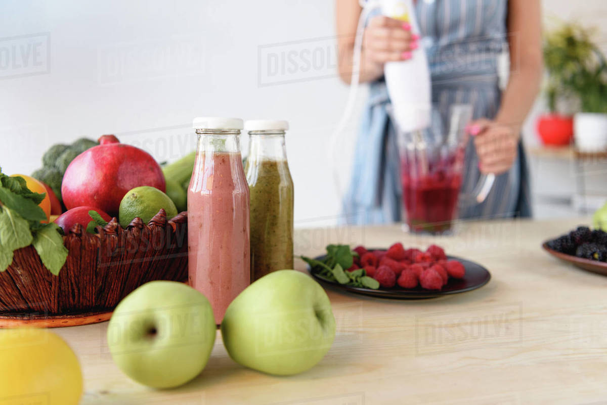 woman cooking homemade detox drink