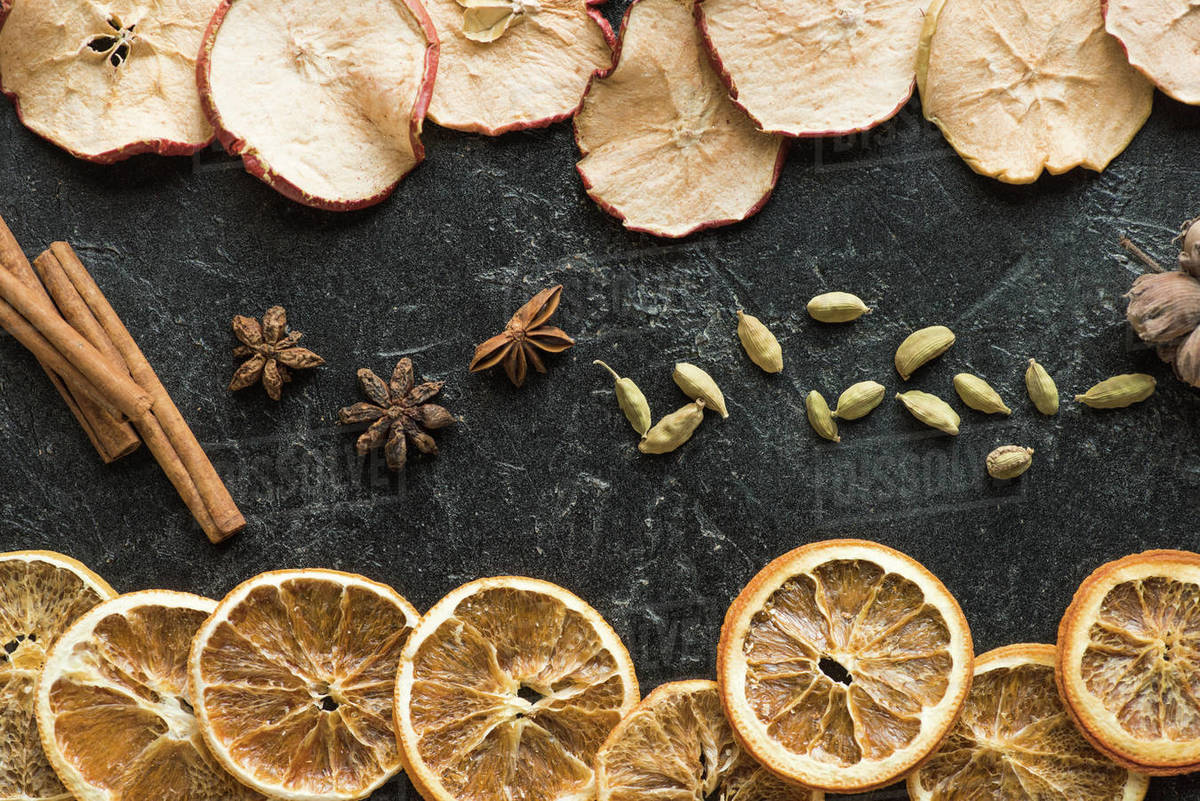 Top view of dried apples and oranges with cinnamon sticks and carnation