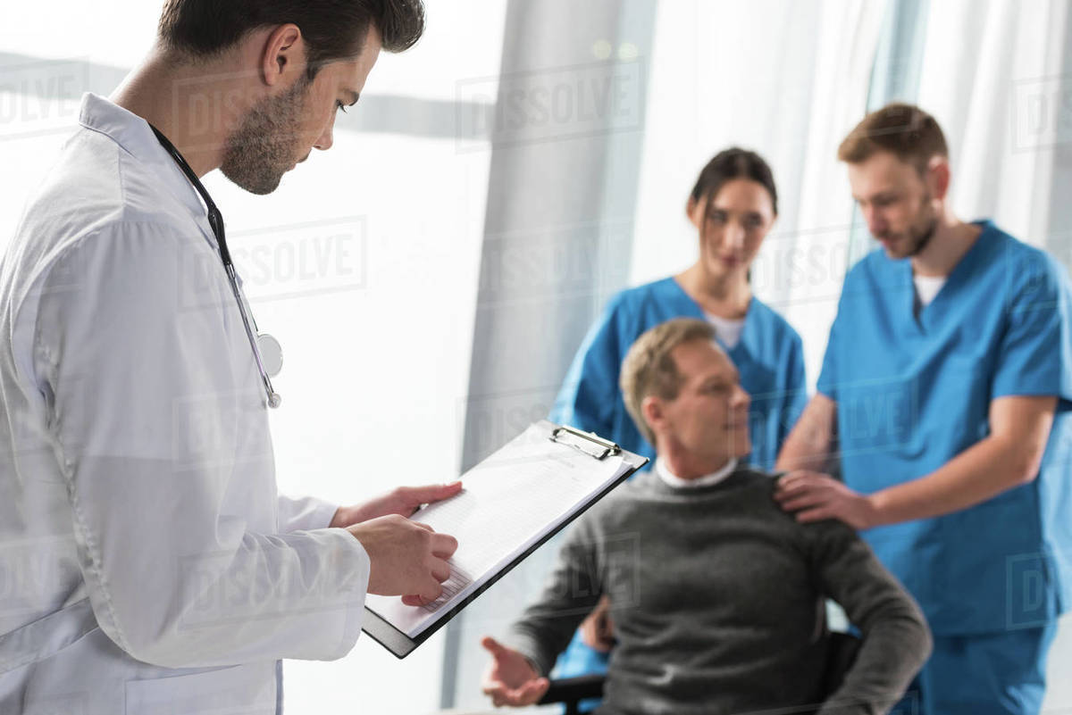 doctor looking at patient medical book in hospital - Royalty-free Stock ...