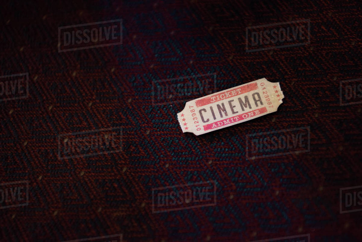 one cinema ticket in movie theater Stock Photo Dissolve
