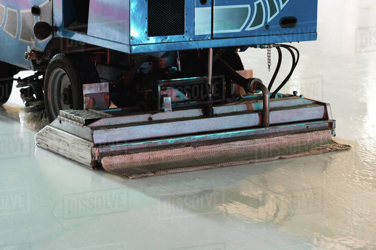 Special machine ice harvester cleaning the ice rink Stock Photo