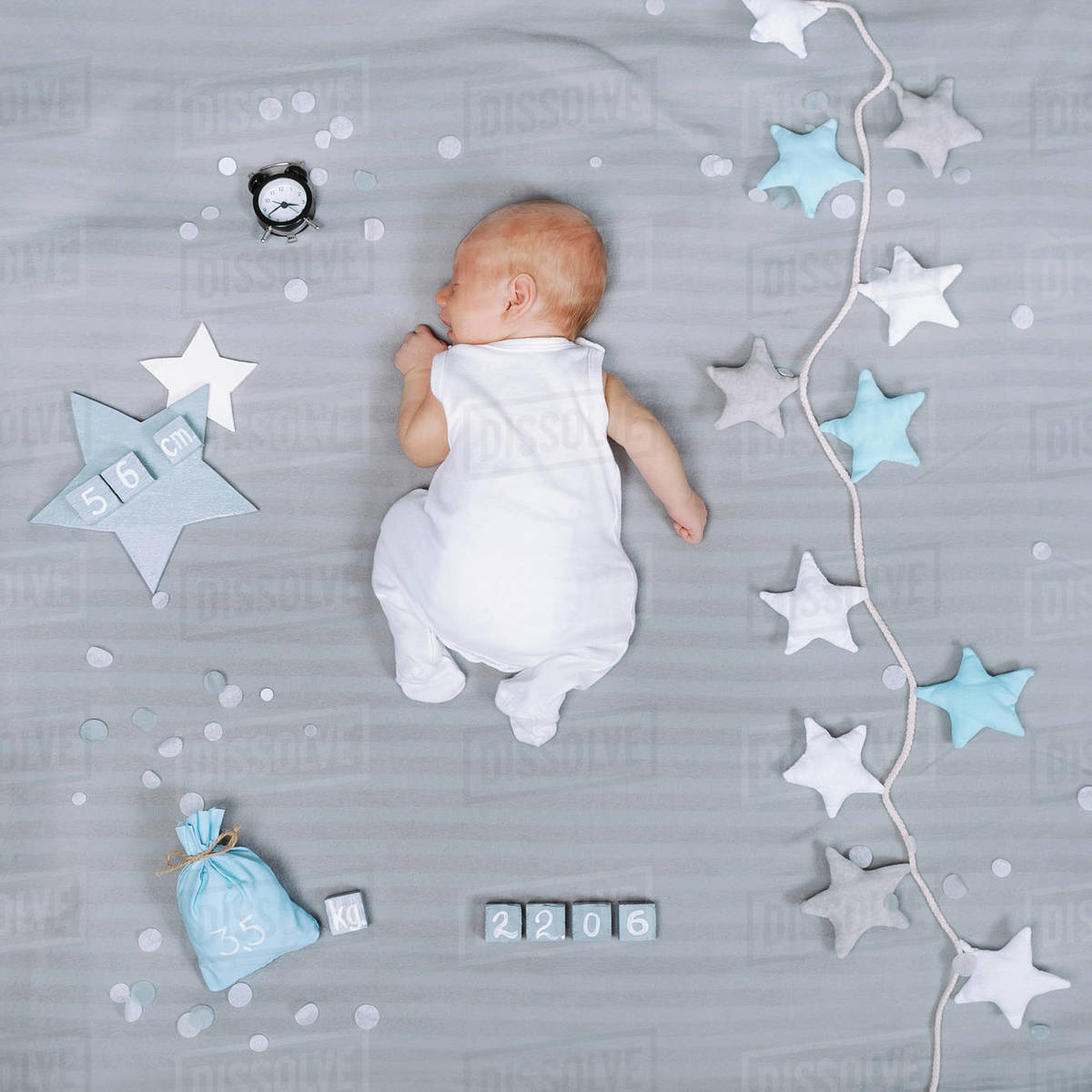 Overhead view of adorable sleeping infant baby with decorations around