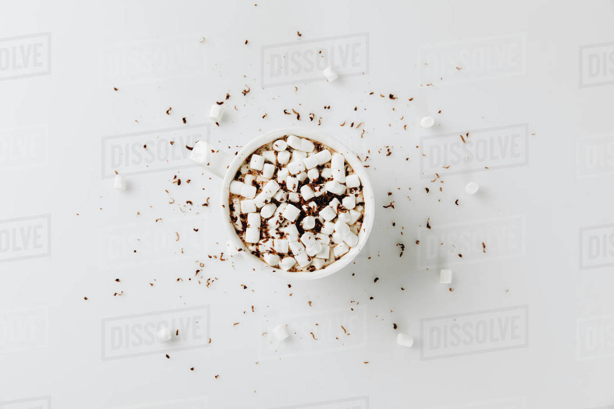Top view of aromatic hot chocolate with marshmallows in cup, isolated