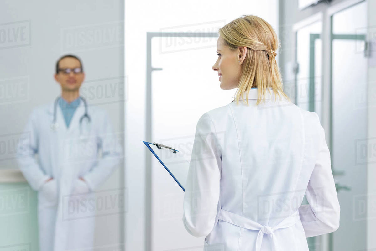 female doctor in white coat with diagnosis in hospital, colleague