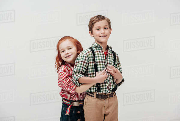 adorable little kids hugging and smiling at camera isolated on grey ...