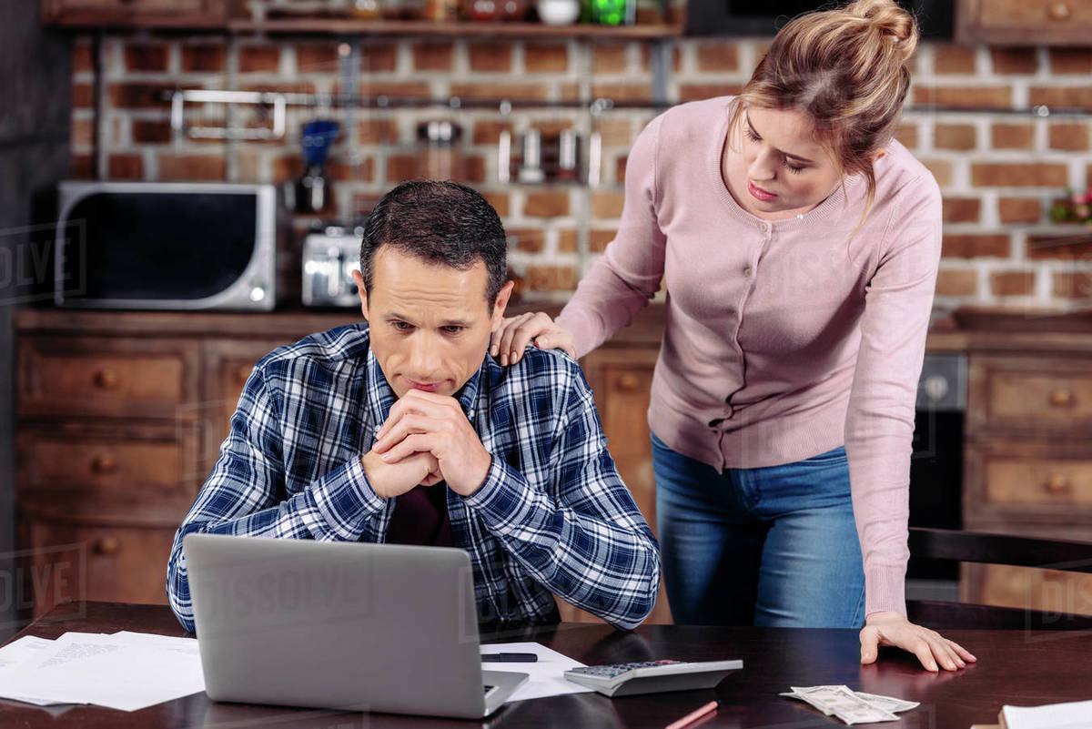 Portrait of woman cheering up upset husband that sitting at table with(02)