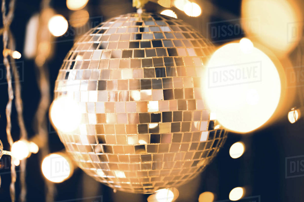 golden glossy disco ball with christmas lights around Stock Photo