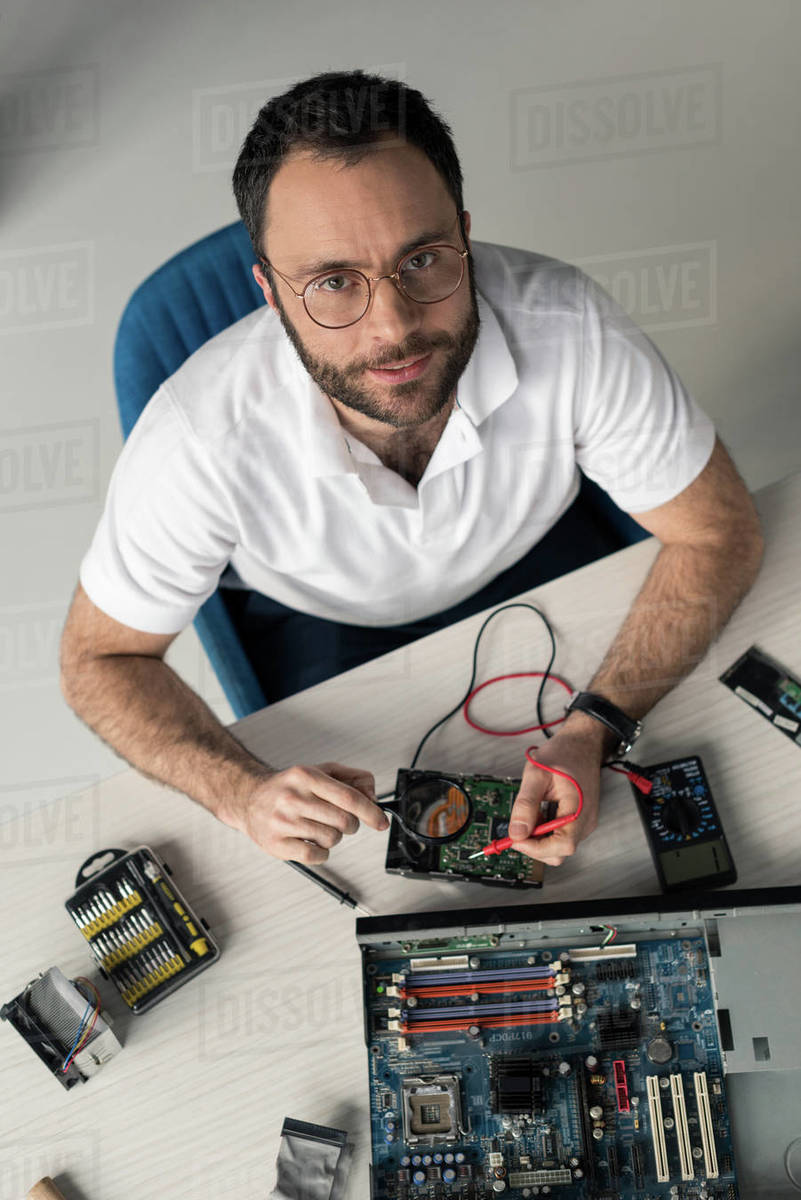 Man using multimeter while testing hard disk drive - Royalty-free Stock ...