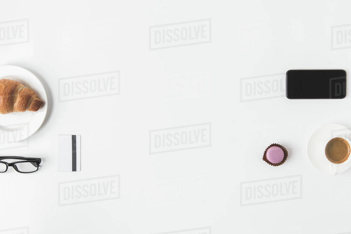 flat lay with smartphone, credit card, eyeglasses and breakfast on