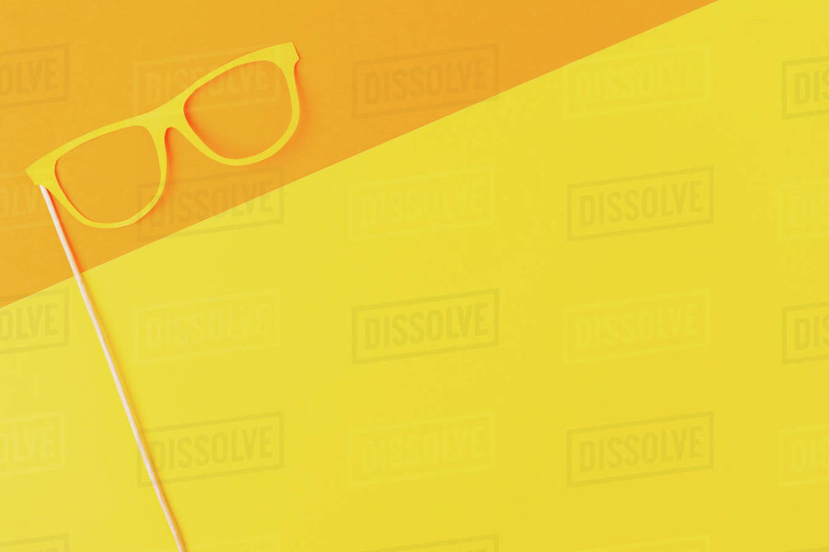 Top view of masquerade mask on yellow and orange background - Stock