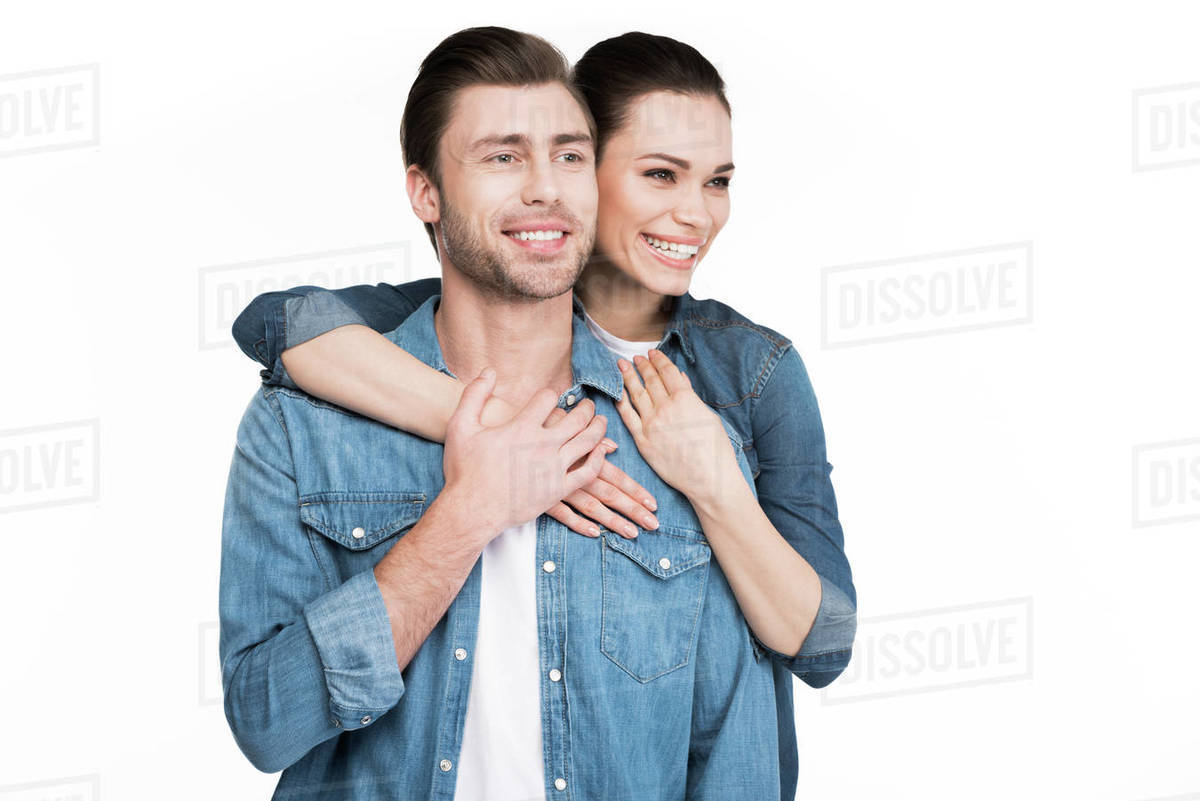 Young smiling couple in denim clothes hugging isolated on white ...