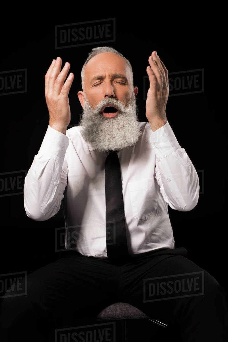 Half Length Shot Of Man In A Suit Sitting On Chair And Throwing Half Length Shot Of Man In A Suit