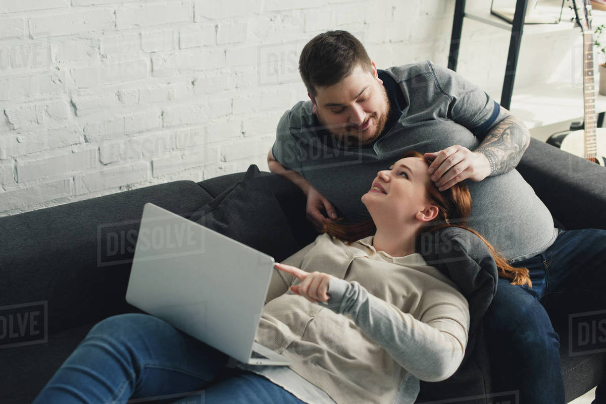 Boyfriend touching girlfriend hair and they looking at each other at