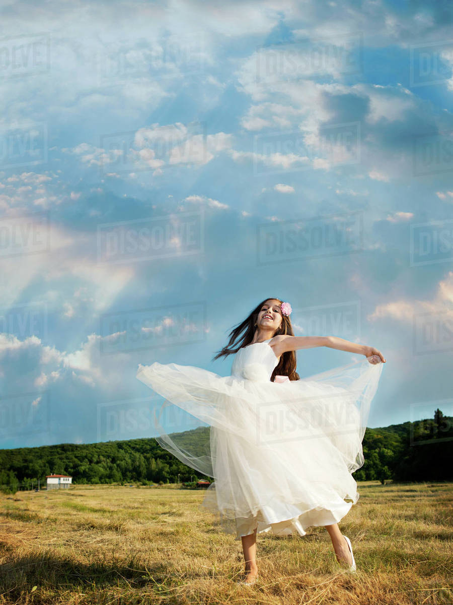 Vertical, outdoors, day, real people, one person, girls, one girl only, children, one child only, 8-9 years, elementary age, caucasian ethnicity, front view, full length, looking at camera, differential focus, standing, dressing up, holding hands, costume, Halloween, halloween costume, fairy costume Royalty-free stock photo