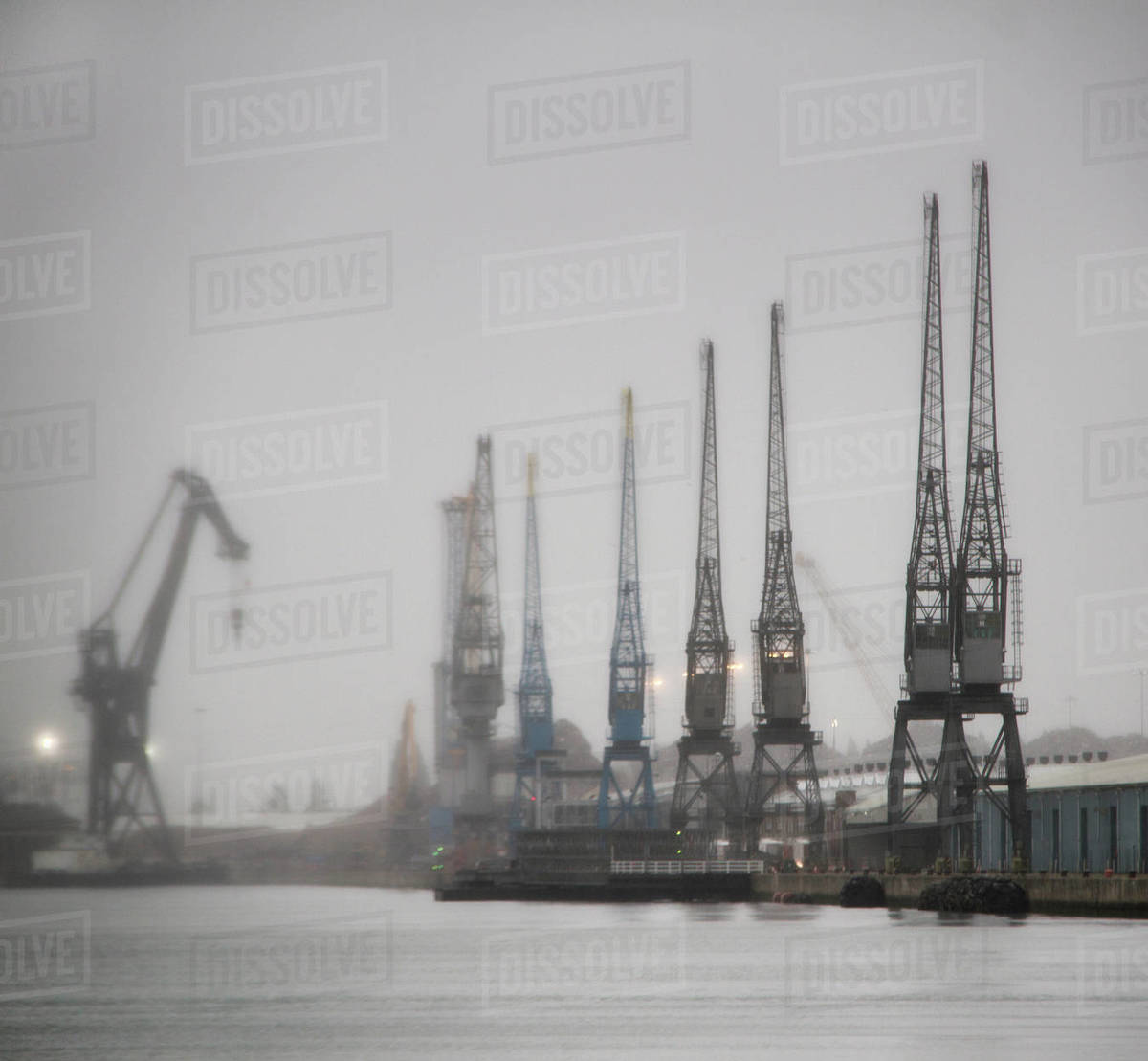 Mechanical cranes at dock Stock Photo Dissolve