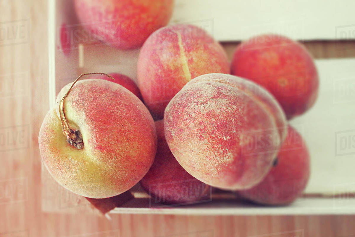 Overhead view of crate of peaches Stock Photo Dissolve