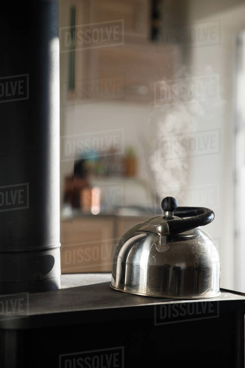 Kettle on a wood burning stove Stock Photo Dissolve
