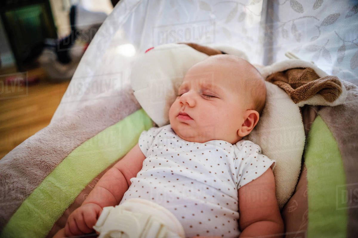 Baby boy sleeping in a baby bouncer Stock Photo Dissolve