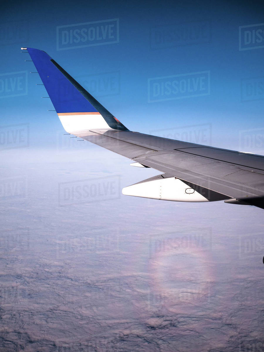 Aircraft in flight above the clouds Stock Photo Dissolve