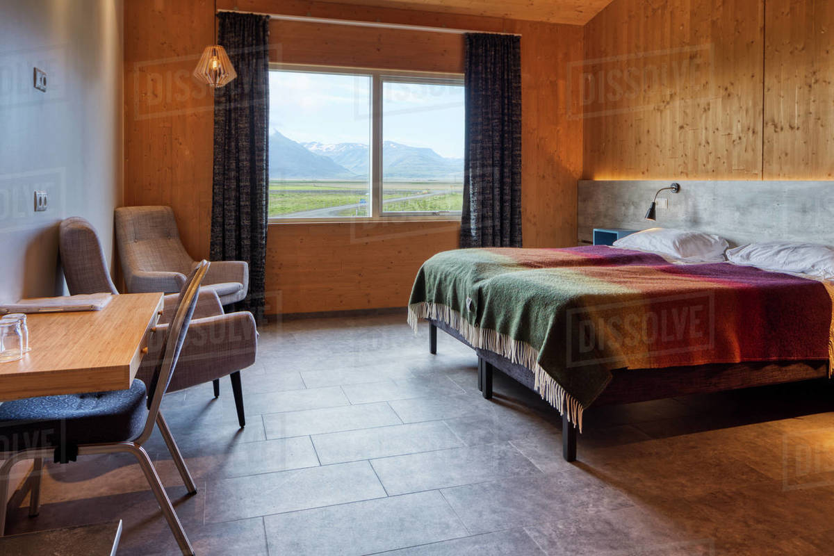 Neat clean cozy bedroom with comfortable furniture and small