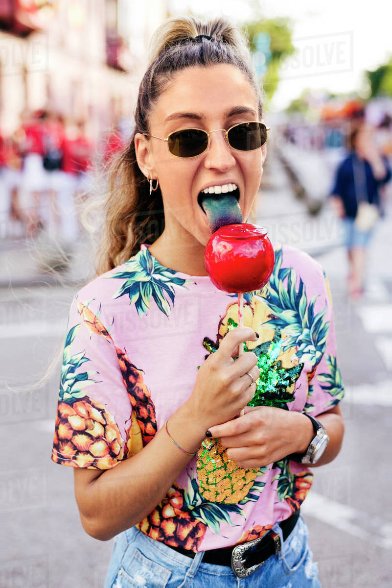 Cheerful lady having fun enjoying sweet candy apple Stock Photo