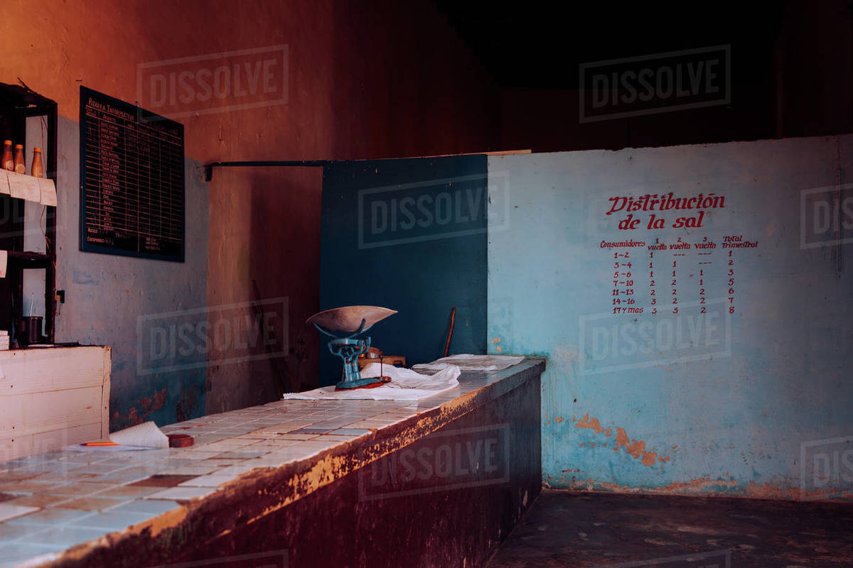 Abandoned cafe with bar counter painted menu and empty shelves on blue