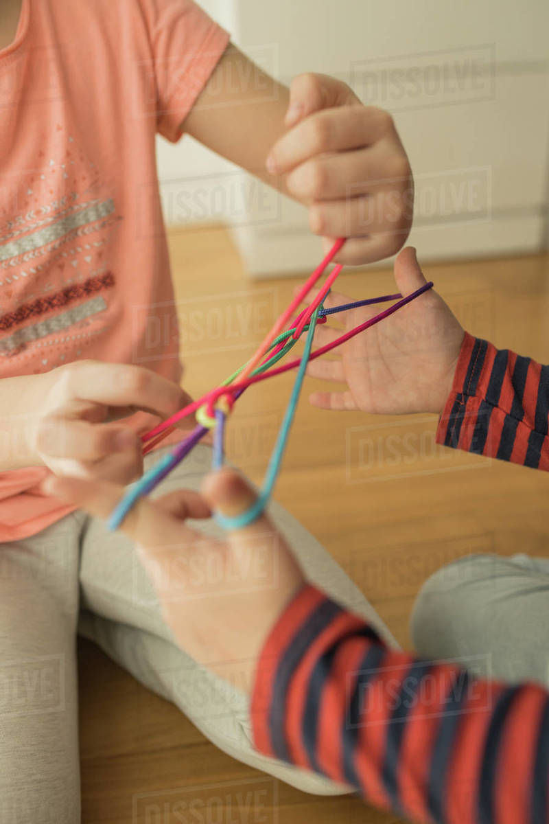 Smart children using rubber bands for game Stock Photo Dissolve