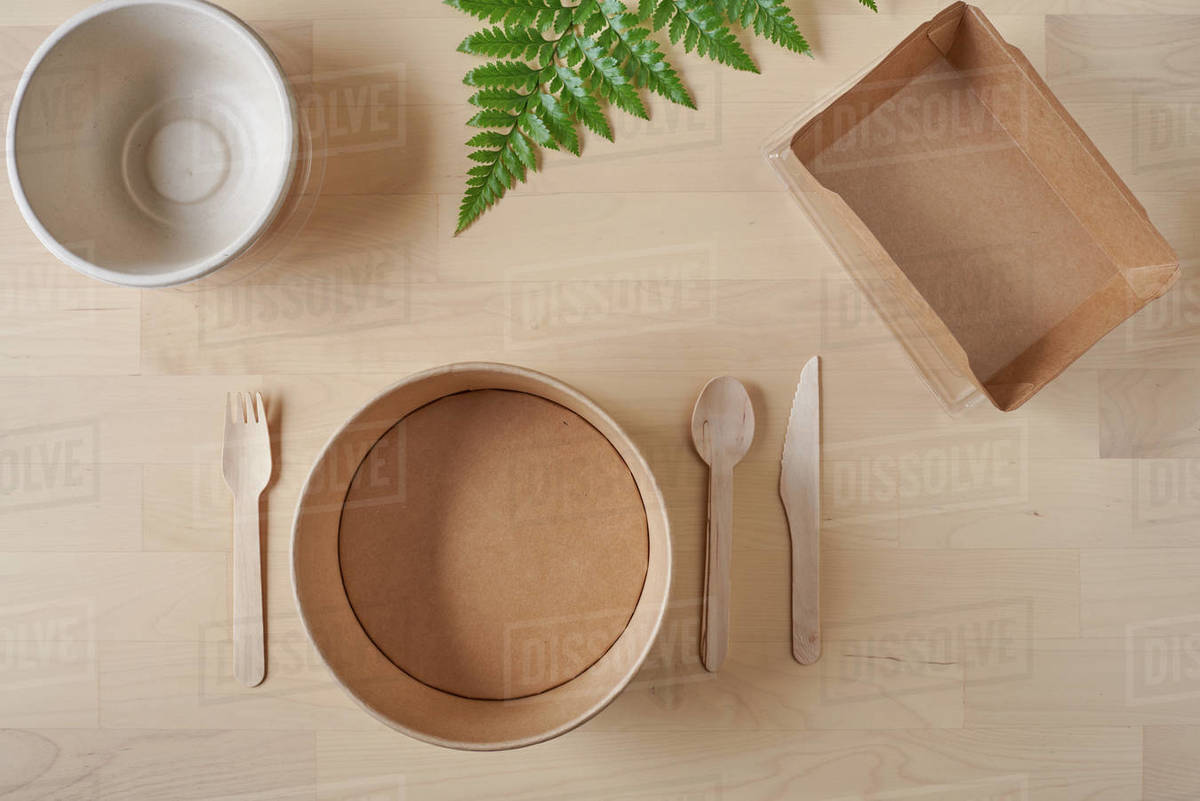 Top view of recyclable carton food package and wooden fork and knife