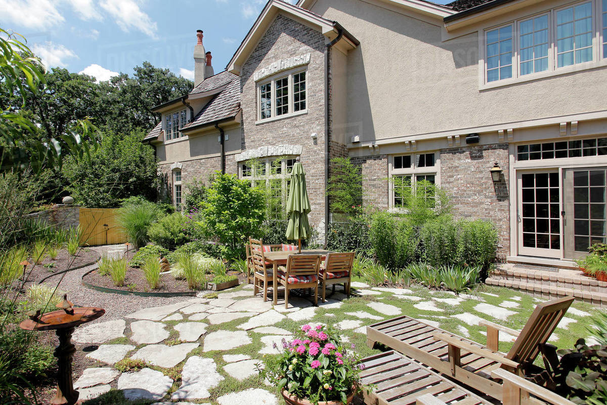 Patio of upscale home with stone steps and gravel. Stock Photo Dissolve