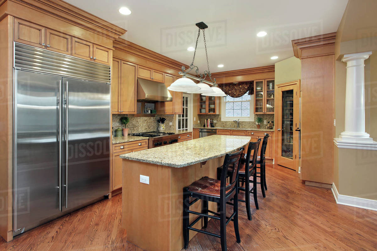 Kitchen in upscale home with large center island. Stock Photo Dissolve
