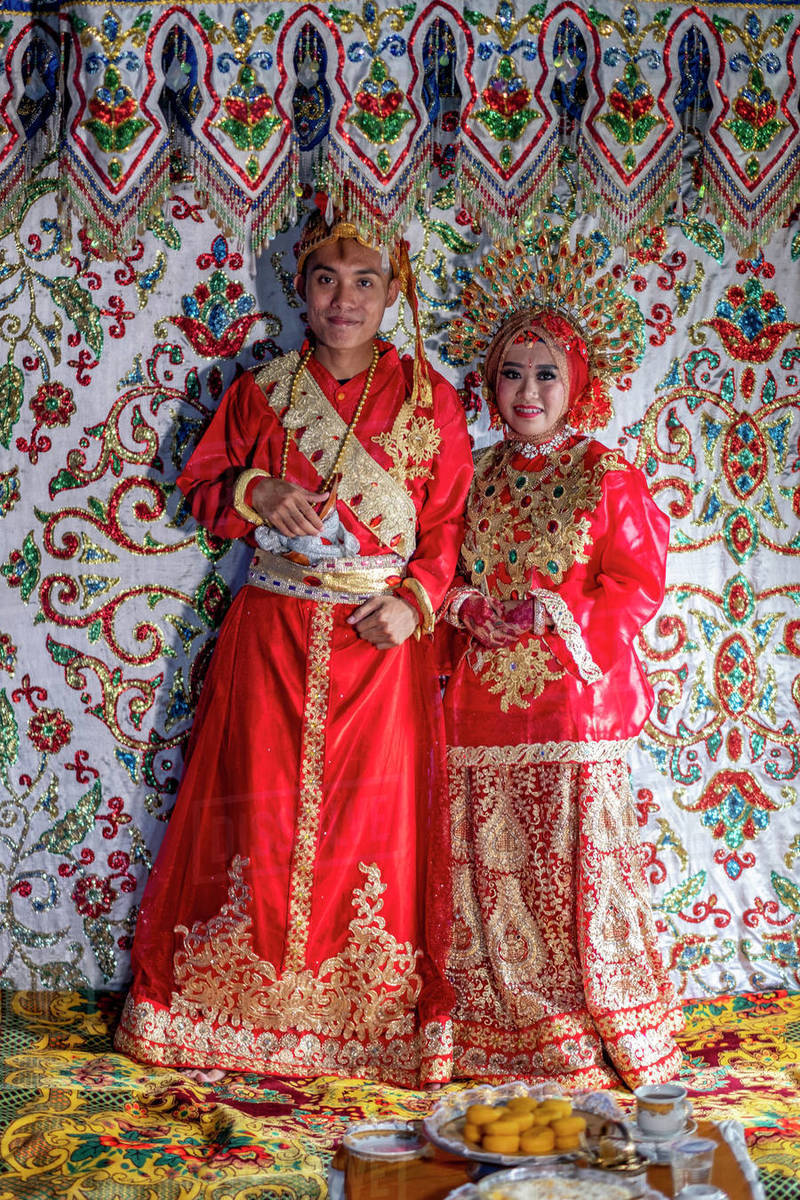 A bride and groom at a traditional Sulawesi wedding, Makassar, Sulawesi, Indonesia, Southeast Asia, Asia Royalty-free stock photo