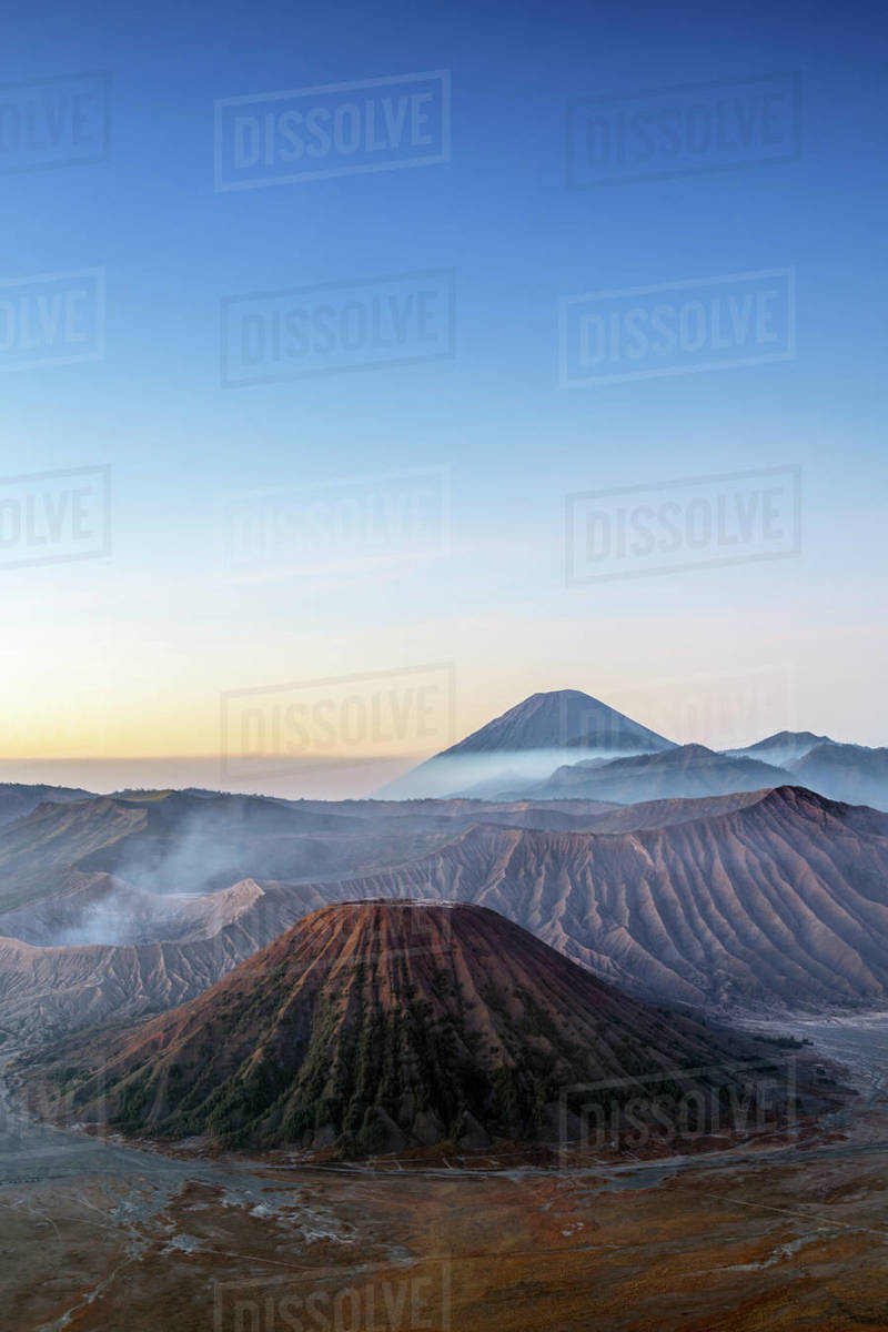 View over volcanic peaks and lava landscapes around Mount Bromo at dawn ...